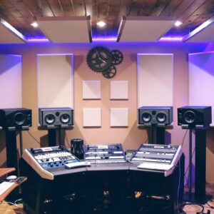 Modern recording studio with high-tech audio equipment and stylish lighting.